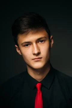 Portrait young guy on a dark studio Stock Photos