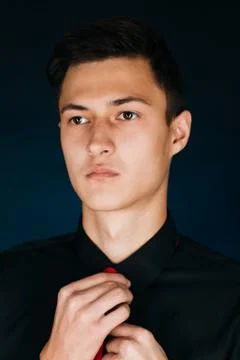 Portrait young guy on a dark studio Stock Photos