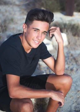 Portrait of a young guy with a nice appearance on the background of nature Stock Photos