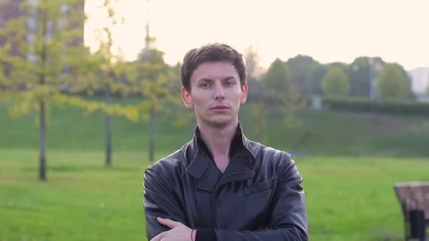 Portrait of a young guy in a park Video stock 79625591