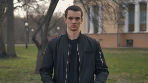Portrait of young guy in protective mask. Young guy puts on a medical face mask  Stock Footage 127341902