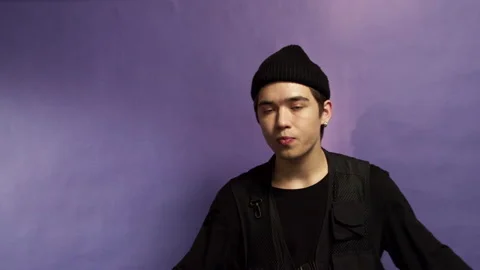 Portrait of a young guy on a purple background Stock Footage 162176666