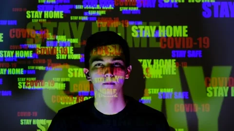 Portrait of young guy puts on protective medical mask to protect the epidemic. C Stock Footage 130249652