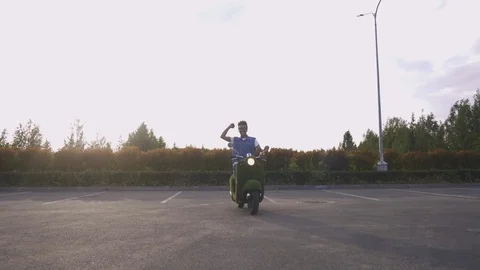 Portrait young guy sitting on his vintage retro motorbike. biker wearing jeans Stock Footage 111594436