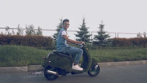 Portrait young guy sitting on his vintage retro motorbike. biker wearing jeans Stock Footage 111594624