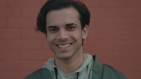 Portrait of young guy smiling on camera outdoors Stock Footage 163828790