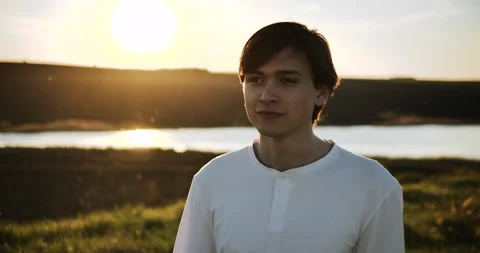 Portrait of a young guy on a sunset background Stock-Footage 153880483