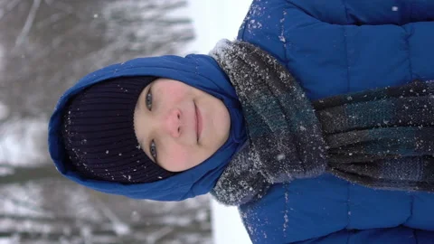Portrait of a young guy in the winter forest, snow falls Stock-Footage 100934771