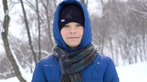 Portrait of a young guy in the winter forest, snow falls Stock Footage 101208729