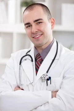 Portrait of young handsome doctor Stock Photos