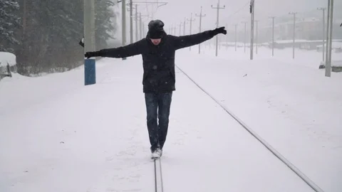 Portrait of a young handsome man with a beard. A bearded man walking on railroad Stock Footage 72737665