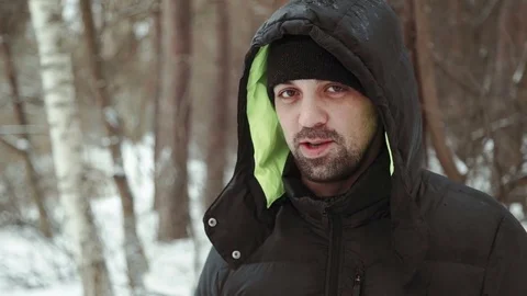 Portrait of a young handsome man with a beard. A bearded man in the winter woods Stock Footage 73635233