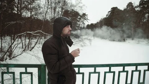 Portrait of a young handsome man with a beard Smokes cigarettes. A bearded man Stock Footage 73637796
