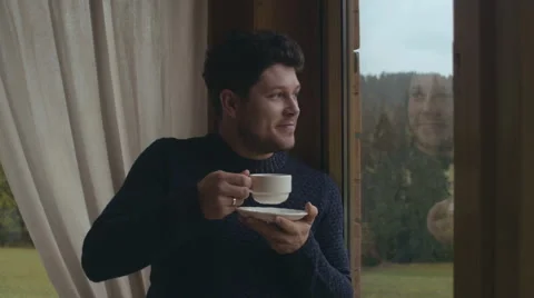 Portrait of young handsome man drinking coffee at home. Stock Footage 56312084