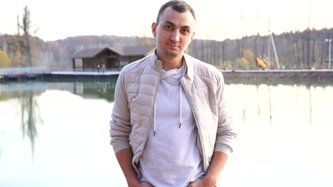 Portrait of a young handsome man in fall clothes. Man wearing white autumn Stock Footage 118516379