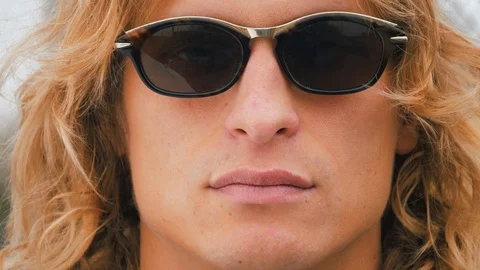 Portrait of a young handsome man, model of fashion, wearing tinted sunglasses Stock Footage 119869883