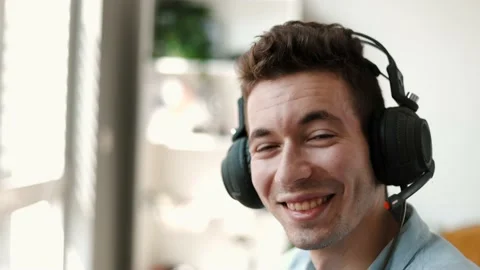 Portrait of young handsome man operator looking at camera smiling Stock Footage 202280348