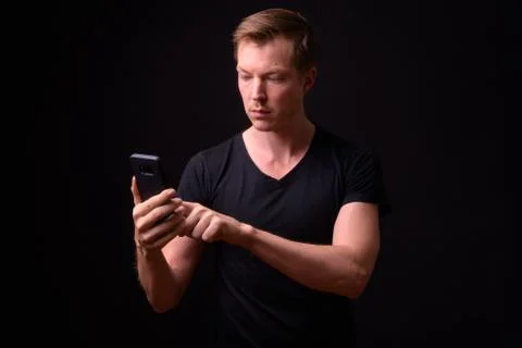 Portrait of young handsome man using phone Stock Photos