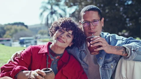 Portrait of Young Happy Couple Drinking Yerba Mate Tea in Park Stock Footage 345384682