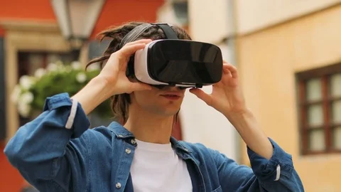Portrait of young hipster man using virtual reality glasses for watching video Stock Footage 81121510