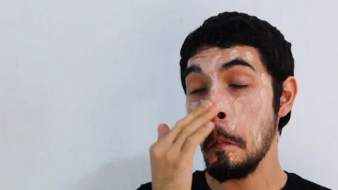 Portrait of young Hispanic man with a beard wearing a hydrating mask Video stock 126948203