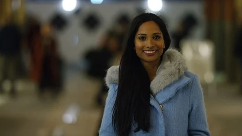 Portrait of young Indian female using her phone and smiling to camera in the hig Stock-Footage 100342079