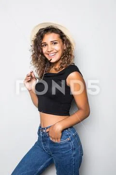 Portrait of a young latino american mulatto girl in a casual and straw hat is Stock Photos