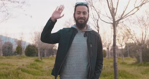 Portrait of young, long haired and bearded hipster guy on sunshine. Smiling s Stock Footage 151644599