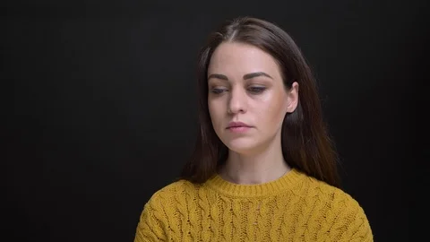 Portrait of young long-haired brunette caucasian girl in yellow sweater having Video stock 102581963