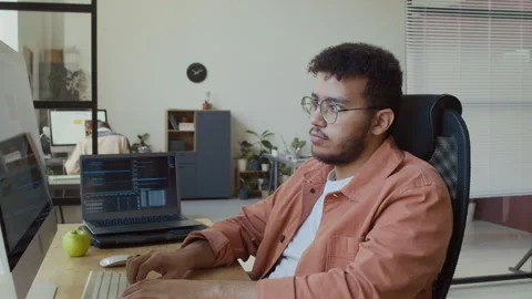 Portrait of Young Male Developer Working on Software Code in Office Stock Footage 293170829