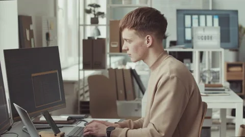 Portrait of Young Male Programmer Coding in Office Stock Footage 219316354