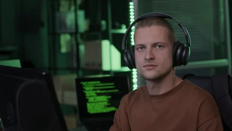 Portrait of Young Male Programmer at Computer Desk in Office at Night Stock Footage 292625196