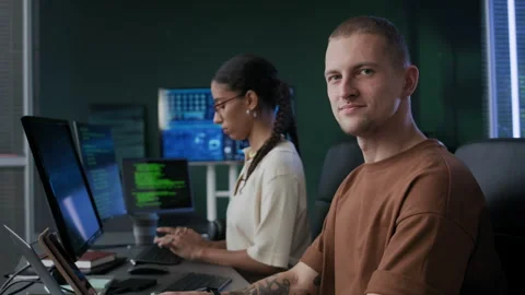 Portrait of Young Male Programmer with His Female Colleague in Office at Night Stock-Footage 292630171