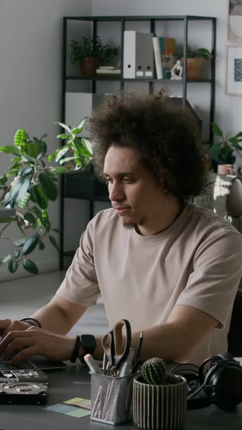 Portrait of Young Male Web Developer Coding on Laptop at Workplace Stock Footage 299200813