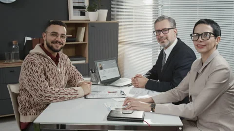 Portrait of Young Man and Two Mature Hiring Managers during Job Interview Stock Footage 330519629