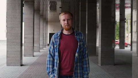 Portrait of a young man on a background of columns. a young man stands on the Stock-Footage 107319043