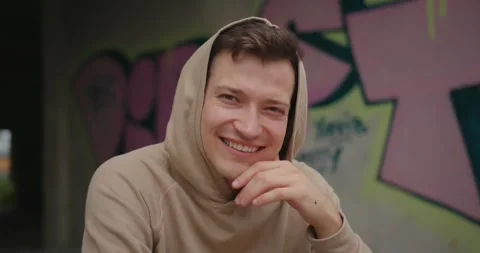 Portrait of a young man on the background of graffiti. Stock Footage 273365459