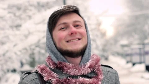 Portrait of a young man in the background of a winter park Stock Footage 82731330