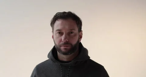 Portrait of a young man with a beard in the studio. 動画素材 253394819