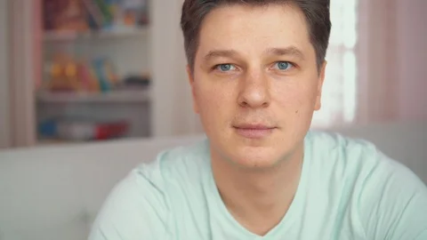 Portrait of a young man. In the bright interior. Stock Footage 102187124