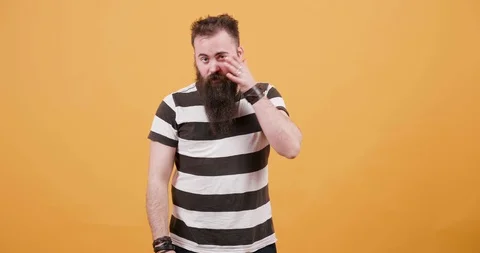 Portrait of a young man caressing his beard and moustache Stock Footage 104052518