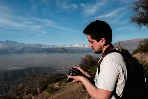 Portrait of young man checking camera on sunny day Stock Photos