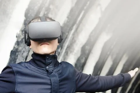 Portrait of a young man enjoys virtual reality glasses Stock Photos
