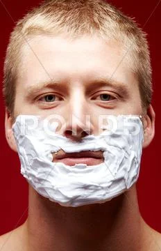 Portrait of young man with foam on face looking upwards Stock Photos
