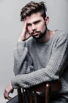 Portrait of a young man in gray pullover. Headache Stock Photos