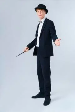 Portrait of young man holding magic wand Stock Photos