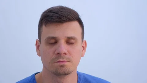 Portrait of young man on light background with small papillomas on eyelids. Video stock 123336747