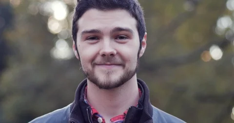 Portrait of a young man with a light beard smiling and looking at the camera Stock Footage 104620653