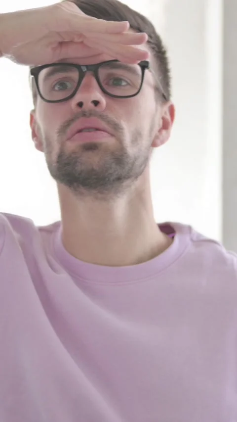 Portrait of Young Man Looking Around, Searching, Vertical Video Video stock 328972084