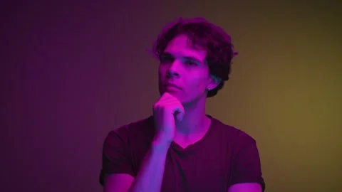 Portrait of Young Man Looking Away with Thinking Face and Considering Thoughts Stock Footage 257782133